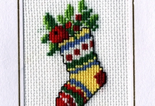 Beeldzijde kerst- en nieuwjaarskaart, sok in kruisjessteek